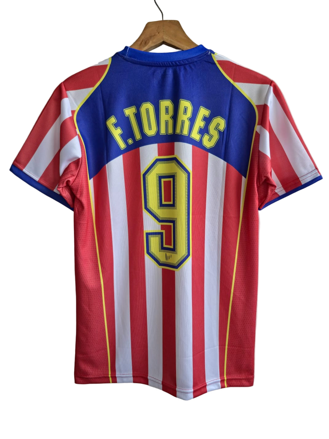 Red and white striped sports jersey with blue collar and yellow text on a hanger against a plain background